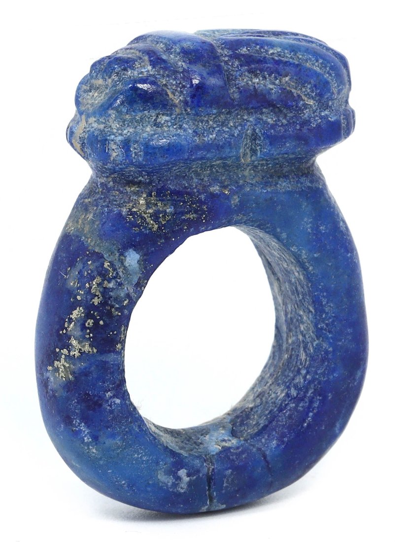 A Coptic Egyptian Lapis Lazuli Scarab Ring, 1st Millennium CE: Crafted in the time-honored traditions of Coptic Egypt, this ring is a remarkable artifact, blending functionality with profound symbolism. The lapis lazuli, a stone of the heavens, prized for its cel