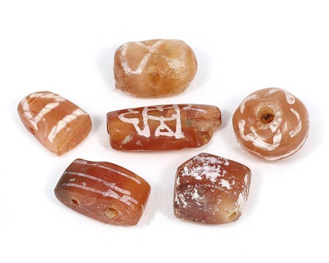 Tibetan Empire Ancient Etched Carnelian Dzi Bead Amulet Set, 7th-9th Century: A lot of six etched carnelian dzi beads, this amulet set hails from the Tibetan Empire, specifically from the 7th to 9th century. Each bead varies in size from 0.9 to 1.4 cm in length, embodying the r