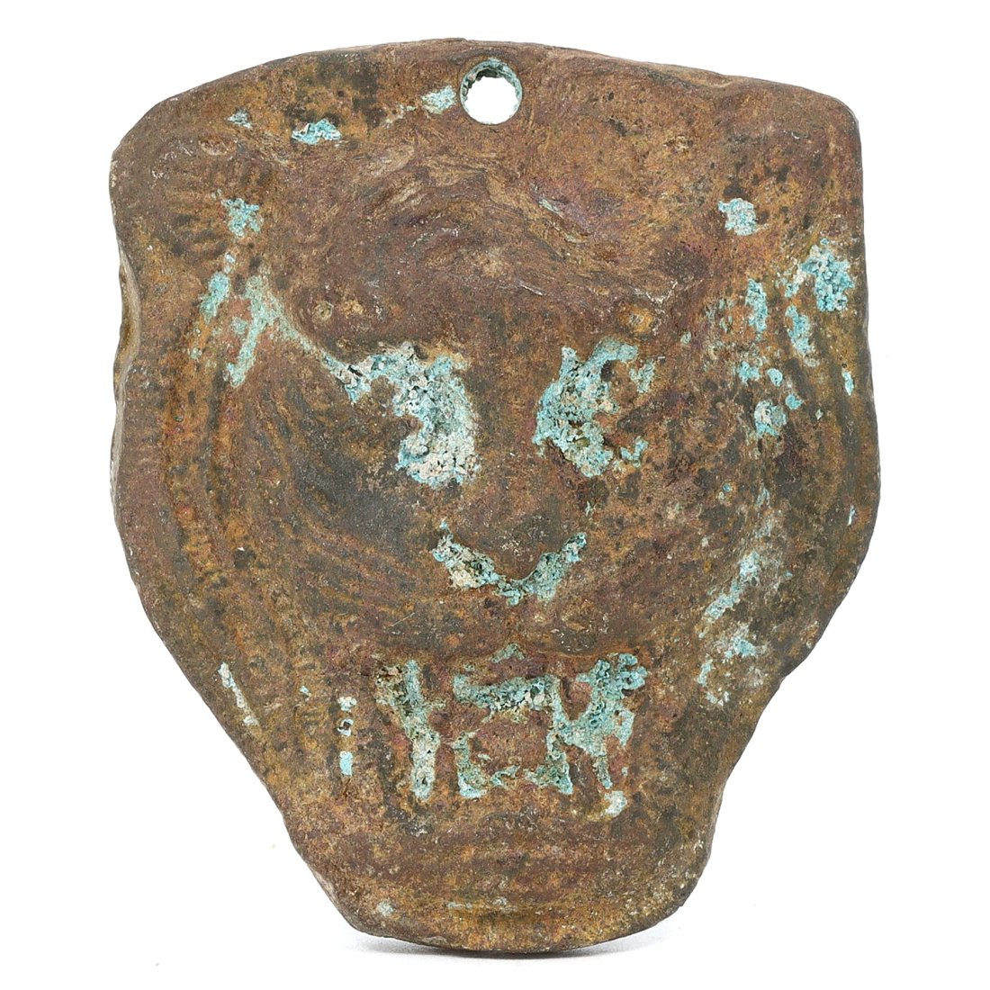 An Egyptian Bronze Tiger Head Amulet, Late Period: This intriguing Egyptian amulet, spanning 5.5 x 4.5 cm, portrays the head of a tiger, a creature not commonly found in traditional Egyptian iconography, suggesting a unique cultural interplay. The inc