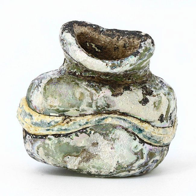 A Roman Miniature Glass Vessel, 1st-7th Century AD: This Roman miniature glass vessel, spanning from the 1st to the 7th century AD, is a fine example of ancient craftsmanship. Measuring 3 cm by 2 cm, its petite form is intricately designed, featuring s