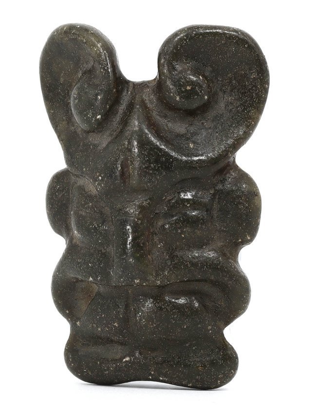 A Hongshan Culture Style Jade Carving, Possibly Neolithic: This archaic jade carving, with its spiral horns and hauntingly abstract facial features, is a modern creation inspired by the Hongshan Culture. Standing 8 cm in height, this piece echoes the deep spi