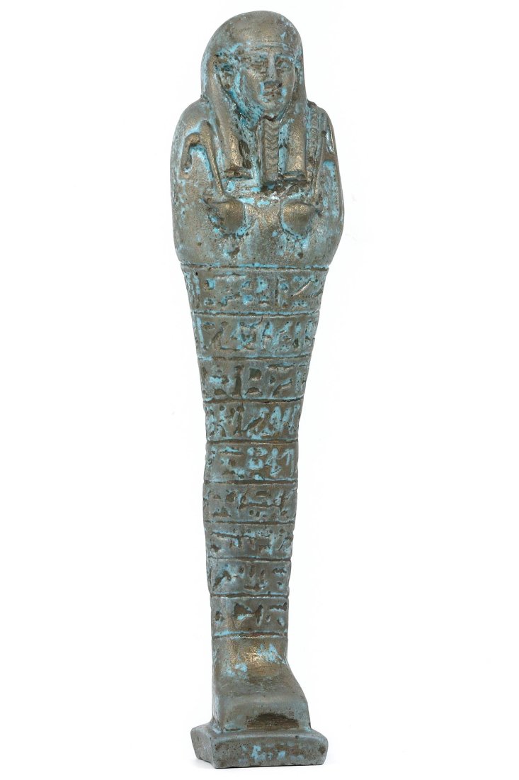 An Egyptian Revival Faience Ushabti with Gilt Highlights, 20th Century AD: In the revivalist spirit of the early 20th century, this elegant faience ushabti with gold gilt accents is a tribute to the ancient Egyptian belief in the afterlife. The figure stands 19 cm tall, its 