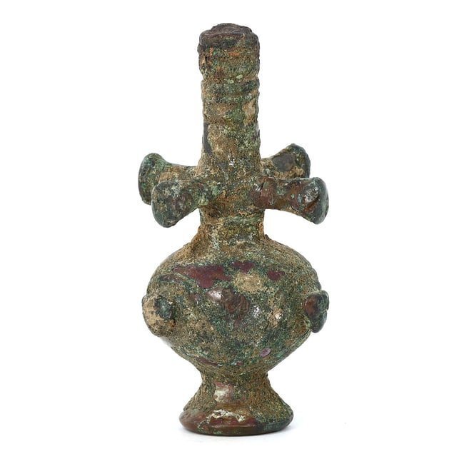 A Luristan Bronze Poppy Flask Finial, Early Iron Age, Circa 1000-650 B.C.: This early Iron Age Luristan bronze finial represents the remarkable metallurgical skill of ancient craftsmen in Western Iran. The distinctive poppy flask shape, combined with the cross motif, suggest