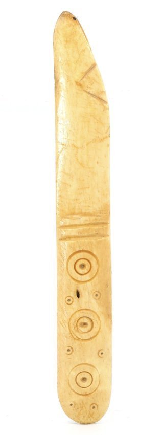 A Viking Age Ritual Bone Knife, Circa 700-1100 AD: This exquisite Viking Age ritual knife, measuring 14 by 2 cm, is a relic of profound historical significance. Crafted from bone, its surface is adorned with concentric circles and dotted patterns, cha