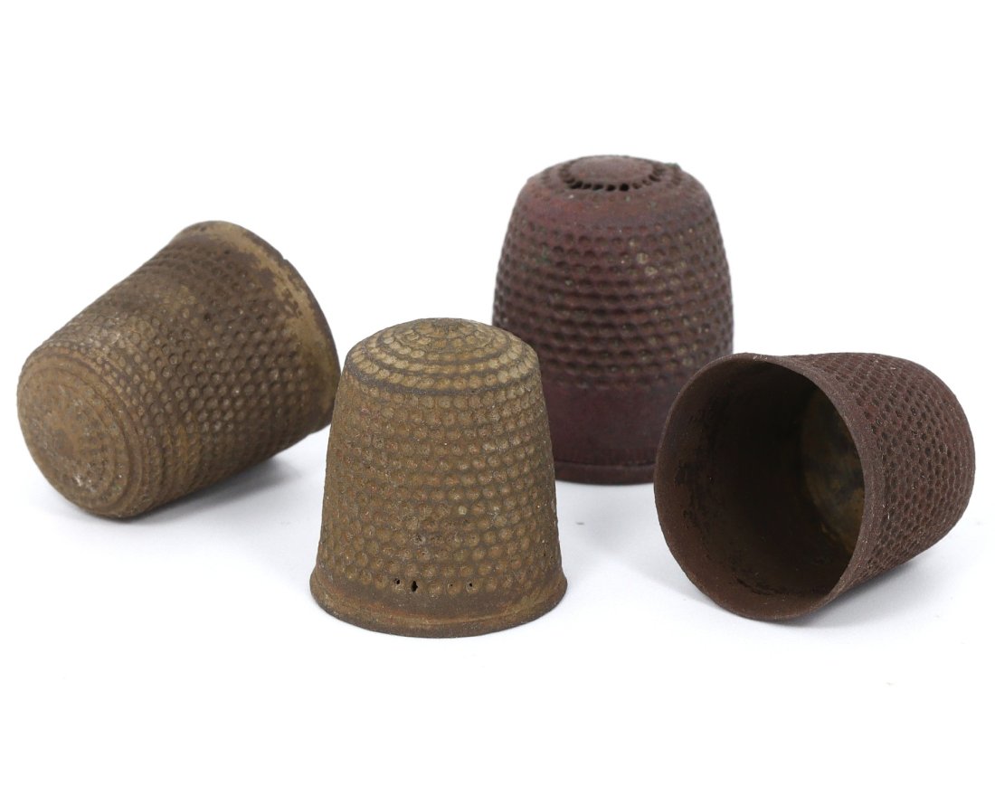 A Quartet of Medieval Bronze Thimbles, c. 14th-16th Century: This set of four medieval bronze thimbles, each with a height of 2 cm, provides a window into the domestic life of the period between the 14th and 16th centuries. The dotted patterns served a function