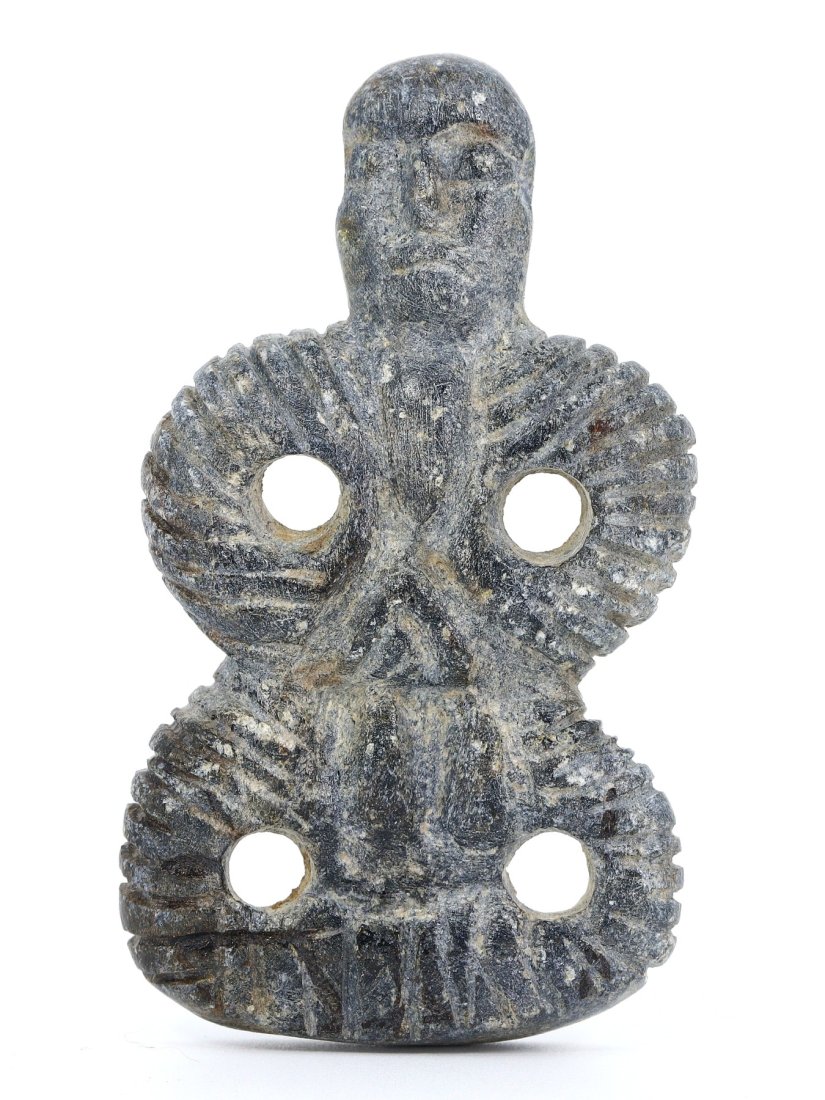 A Bactria-Margiana Steatite Schist Idol, 3rd Millennium B.C.: This steatite schist idol from the Bactria-Margiana region, measuring 7x4 cm, embodies the distinctive cross-legged posture, prevalent in the iconography of the ancient Bactria-Margiana complex. The e