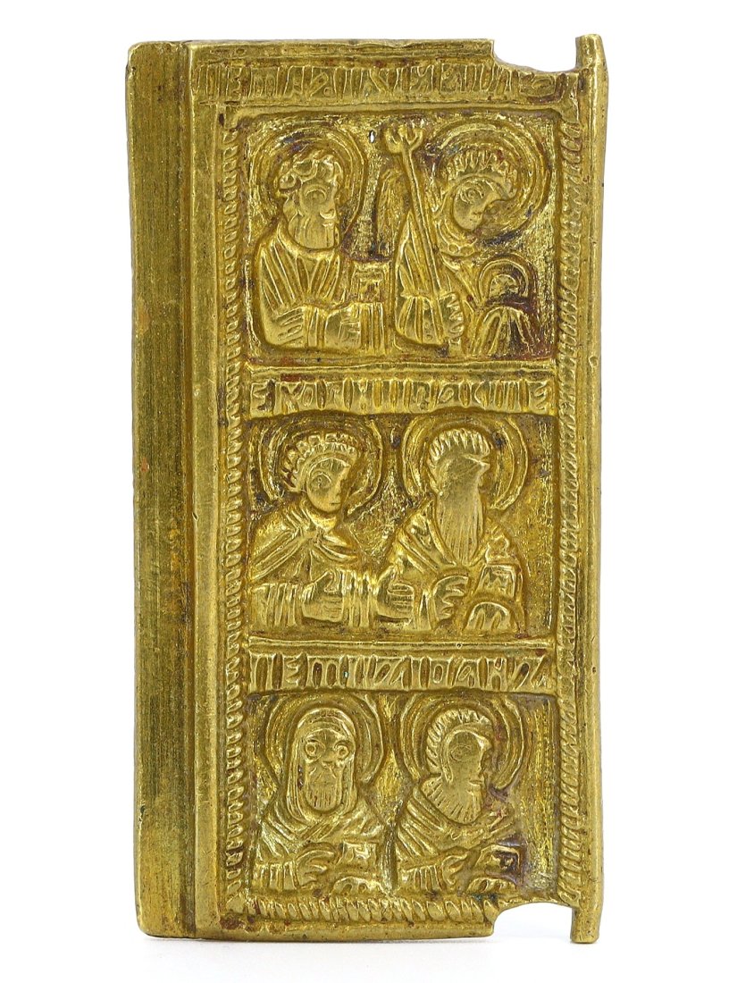 A Byzantine Gilded Brass Icon with Saintly Visions: This gilded brass icon, an artifact steeped in the Byzantine tradition, features embossed figures of saints and holy personages, their visages etched with devotional serenity. With its size and the lu