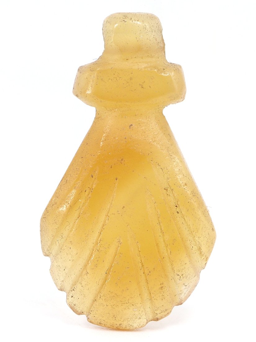 An Ancient Carnelian Coptic Amulet, Early Christian Period, Egypt, 3rd-4th Century AD: This diminutive Coptic amulet, crafted from the warm, translucent tones of carnelian, captures the essence of Early Christian Egypt. Measuring a modest 2.8 by 1.5 cm, its polished surface and minimali