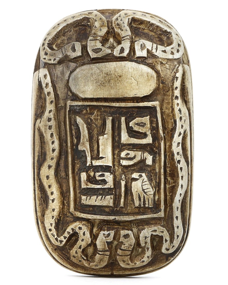 An Ancient Egyptian Steatite Scarab Seal, Post-Pharaonic Period: This steatite scarab seal from the Post-Pharaonic period of ancient Egypt is an emblematic artifact symbolizing transformation and protection. Carved with great precision, the seal features hieroglyph