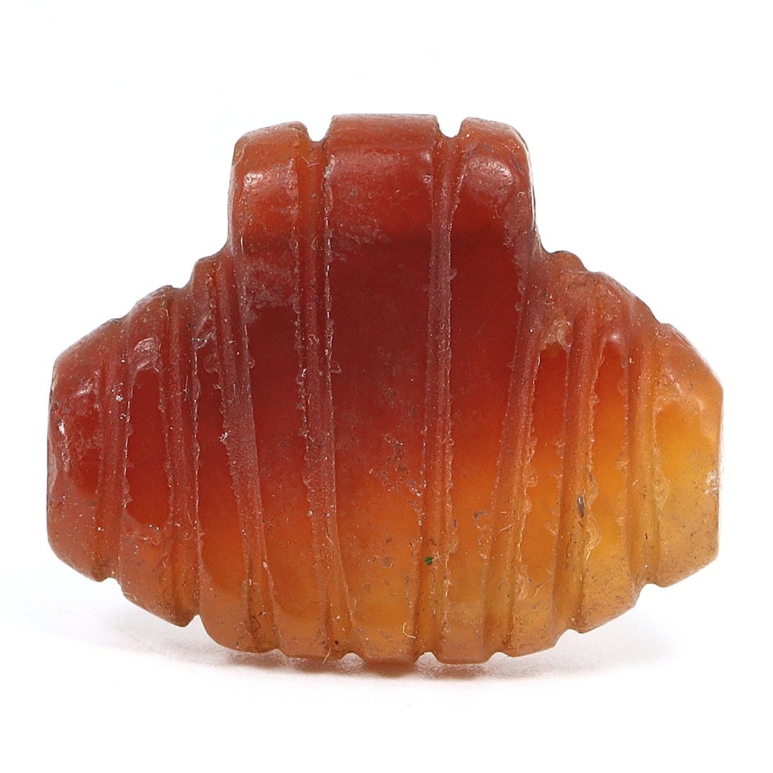 An Ancient Carnelian Coptic Amulet, Early Christian Period, Egypt, 3rd-4th Century AD: A piece of history, this Coptic carnelian amulet from early Christian Egypt is a testament to religious fervor and personal piety. The warm, fiery hues of the carnelian stone transition from a deep, b