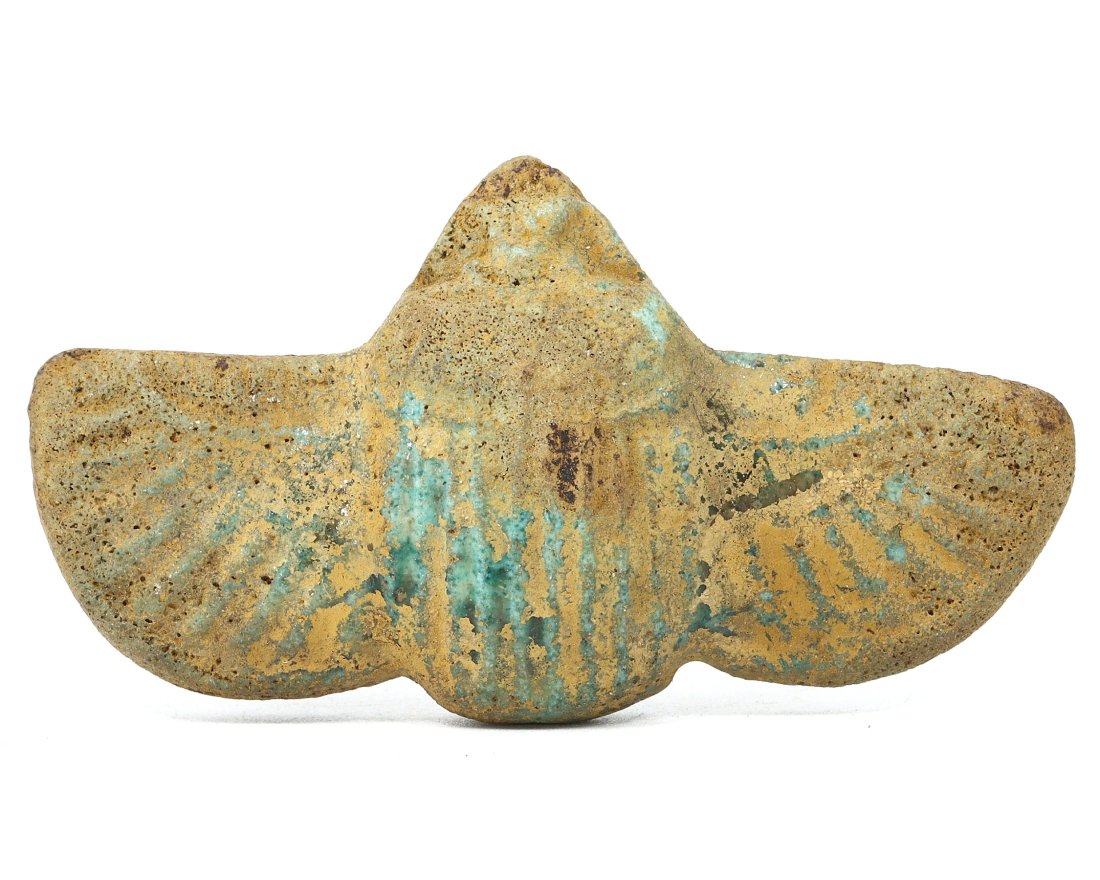 Ancient Egyptian Glazed Terracotta Winged Scarab Amulet, New Kingdom 1550-1070 BC: The piece presented is a fine example of New Kingdom artistry, a glazed terracotta winged scarab, measuring 6 by 3.3 cm. Its faded blue-green glaze speaks to its antiquity, with wear that suggests it 