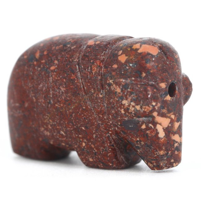 A Medieval Jasper Elephant Amulet, Circa 5th-15th Century AD: This robust jasper amulet, carved in the form of an elephant, is a remarkable relic from the Medieval period, dating between the 5th and 15th centuries AD. The stone’s deep russet tones, flecked wit
