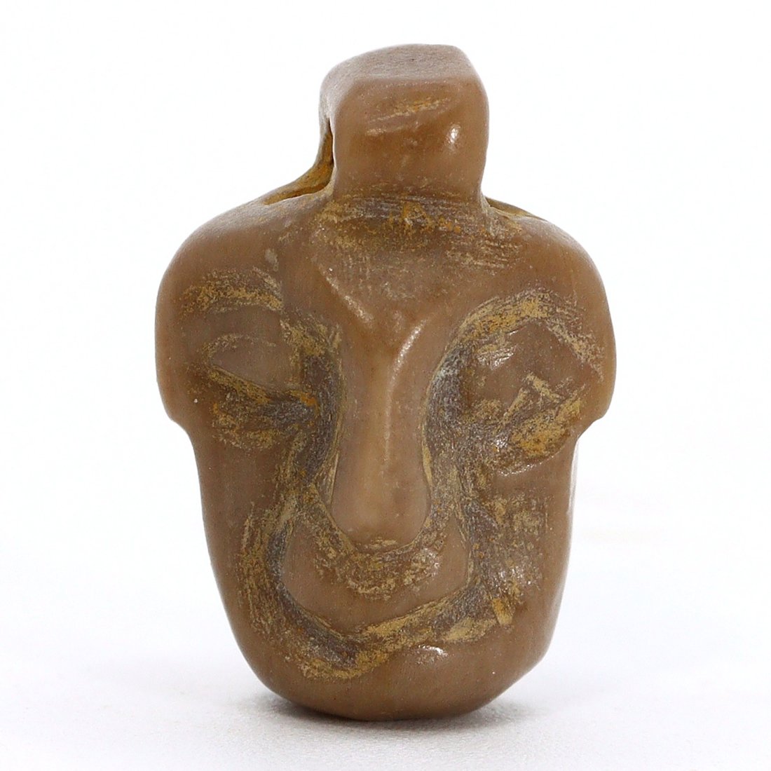 A Coptic Stone Head Amulet, Egypt, Circa 4th-6th Century A.D.: Carved from a dense, stone material, this Coptic amulet of 1.6x0.8 cm exhibits the stylized form of a human head or face, indicative of the symbolic religious art of Coptic Egypt between the 4th and 6