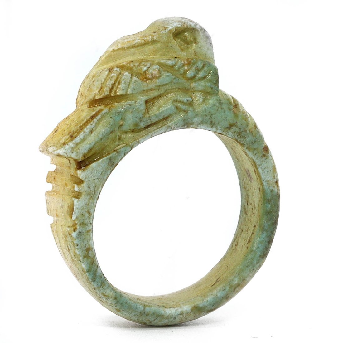 An Ancient Egyptian Glazed Steatite Bird Ring, Post-Pharaonic Epoch: This elegant ring, crafted from glazed steatite, features the delicate carving of a bird, a testament to the continuity of craftsmanship beyond the Pharaonic epoch. The soft green patina and precise i