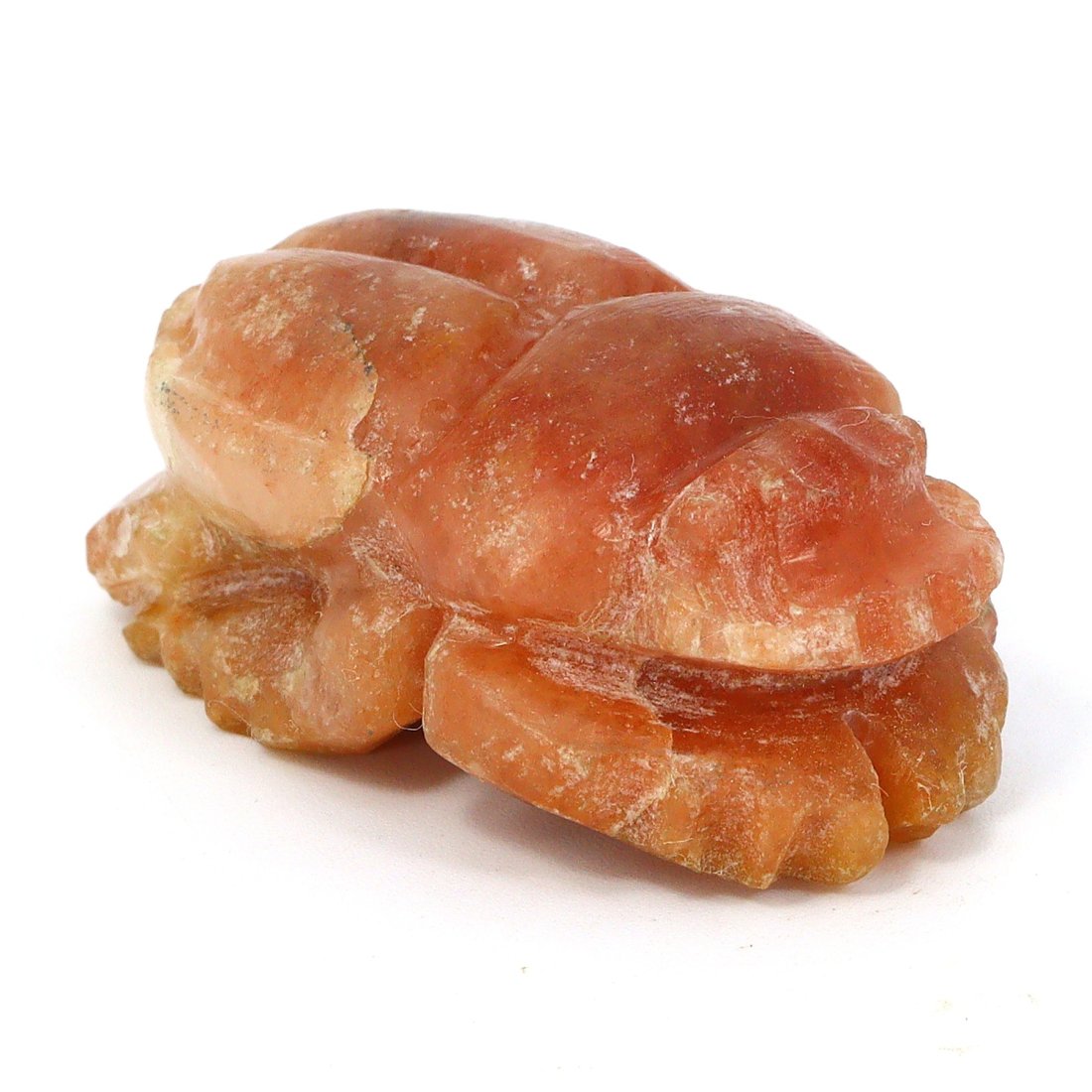 An Ancient Egyptian Carnelian Scarab, Post-Pharaonic Period: This exquisite carnelian agate scarab, a relic from the Post-Pharaonic Egypt, exudes a warm, translucent orange hue, characteristic of the coveted carnelian stone. The piece, though small in stature, 