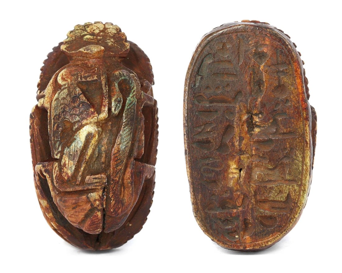 An Ancient Egyptian Glazed Steatite Scarab Stamp with Inscription: This exceptional scarab stamp, 5.5 x 3.5 cm, is a relic from Egypt's vast history, carved from steatite and finished with a glaze that has maintained much of its luster over the millennia. The undersi
