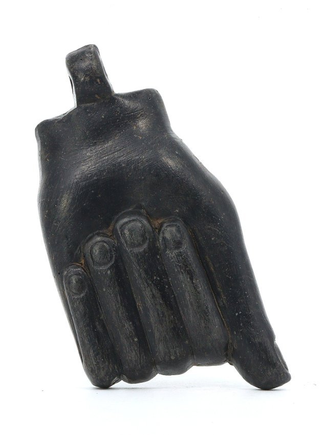 An Ancient Egyptian Post-Pharaonic Steatite Amulet of a Clenched Fist: This steatite amulet from the enigmatic Post-Pharaonic epoch in ancient Egypt manifests as a symbol of strength and determination, a clenched fist. Painted to endure the test of time, the black hue ma