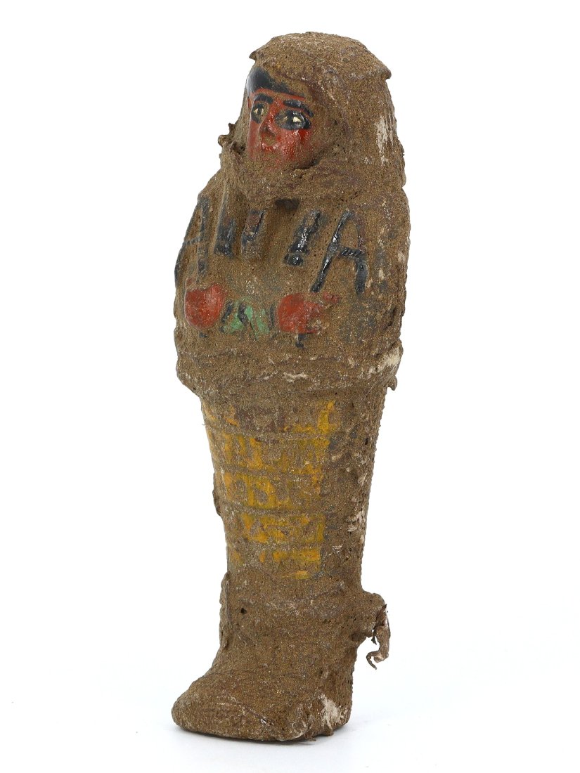 An Ancient Egyptian Sentinel Faience Ushabti with Hieroglyphic Inscriptions: Envision the hallowed necropolis, where this sentinel ushabti once stood among thousands, a silent servitor for the afterlife. Clad in faience, its visage bears the mystical hieroglyphs, invoking the 