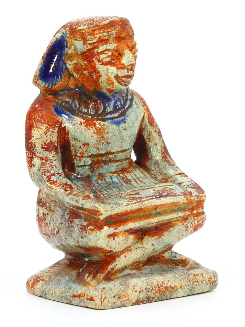 An Ancient Egyptian Steatite Figurine of Amenhotep, Protector of the Home: This steatite figurine, standing 8.6 cm in height, is steeped in the rich history of Ancient Egypt, representing Amenhotep, known as the protector of the home and hearth. The intricate glazing, a tape