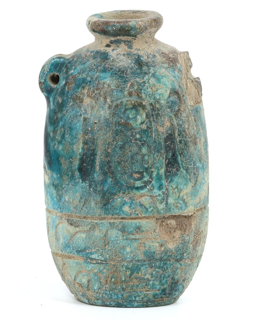 An Ancient Egyptian Glazed Steatite Jar with Hieroglyphs: This petite jar, a mere 6 cm in height, may have once held precious unguents or medicines, its body adorned with hieroglyphs that speak of its contents or owner. The vibrant turquoise glaze, now with 