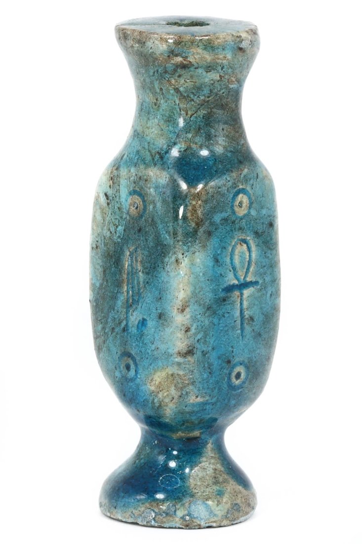 An Ancient Egyptian Glazed Steatite Vessel, Post-Pharaonic Epoch: This exquisite vessel, standing at 7 x 2 cm, is a fine example of the artisanal legacy of post-Pharaonic Egypt. The vessel's vivid turquoise glaze captures the eye, while its form and the precision of