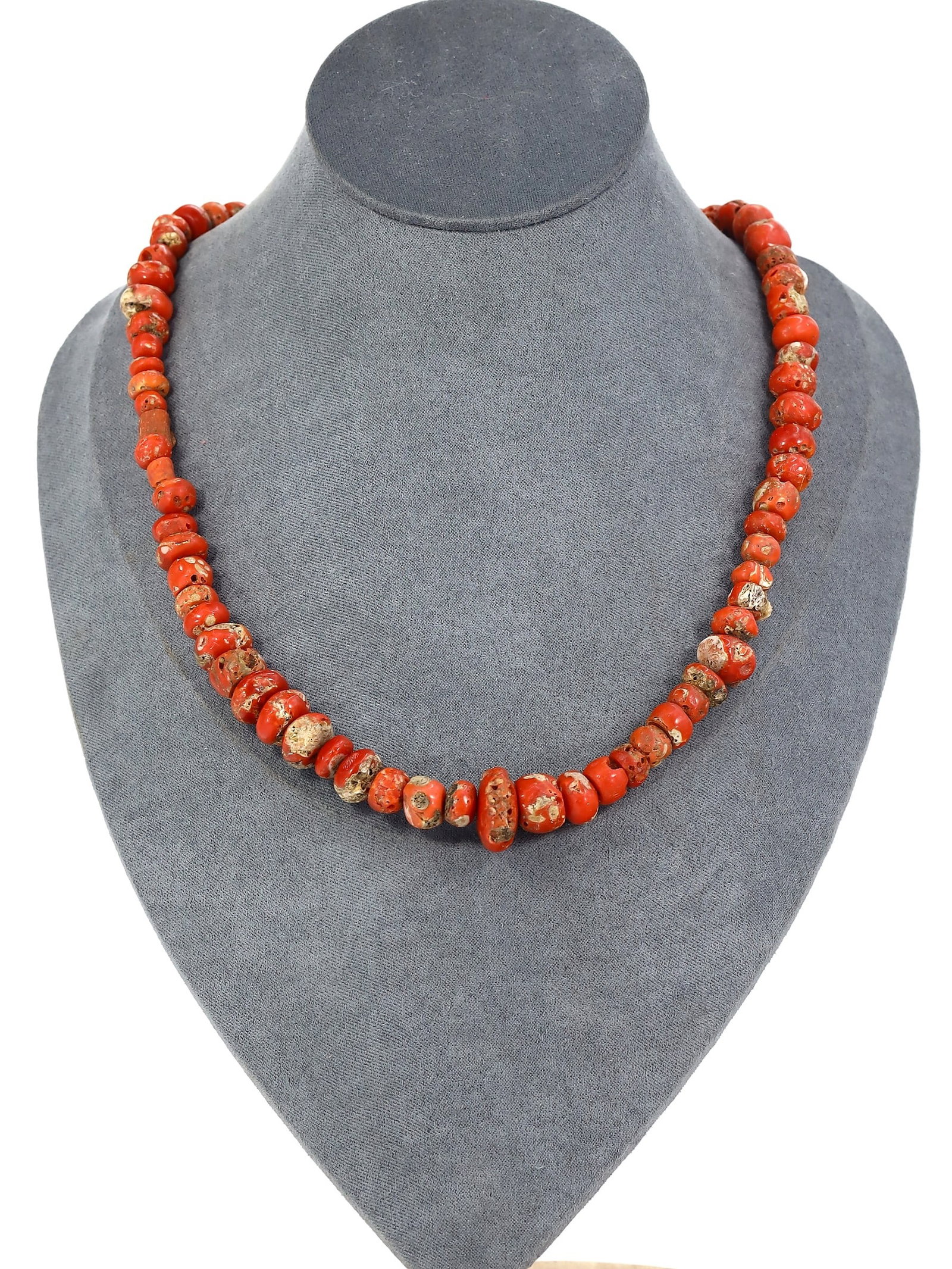 An Ancient Tibetan Red Coral Bead Necklace: Draped in the vibrant echoes of Tibetan culture, this necklace is a cascade of deep red coral, each bead a testament to the artistry of ancient hands. The organic allure of the coral, shaped by time a
