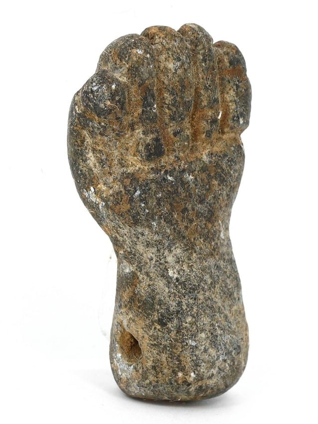 An Egyptian Diorite Fist Amulet, Late Period to Ptolemaic: This robust diorite fist amulet from ancient Egypt, measuring 3.5x2x1 cm, is a striking example of symbolic protection. Diorite, a durable and esteemed stone, was chosen for its strength and longevity