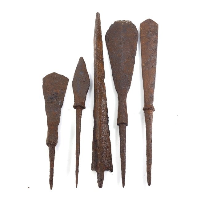 A Quintet of Iron Arrowheads/Spearheads, Likely Roman Era: This quintet of iron objects includes items that may have served as both arrowheads and spearheads, indicative of Roman military equipment. The larger sizes, ranging from 8.5 to 13 cm, and the robust 