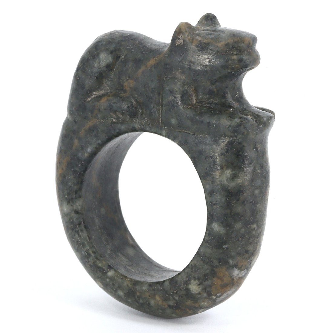 An Egyptian-Inspired Stone Carved Ring Bearing the Form of a Stoic Lion: A relic of profound craftsmanship, this stone ring captures the essence of a guardian lion—symbol of protection in ancient Egyptian culture. Carved from a monolithic stone, its presence is as comman