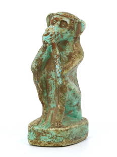 An Guardian of Knowledge, Faience Baboon Amulet: Behold the time-honored craftsmanship of this amulet, a miniature sentinel in faience. This charming baboon, with its contemplative pose, evokes the sacred scribe god, Thoth, symbolizing wisdom and