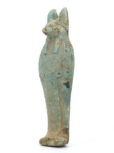 An Egyptian Guardian of the Afterlife Anubis Ushabti: Step into the realm of the divine with this faience Anubis ushabti, a guardian not just of the afterlife but of the rich history it carries. Standing at 13 centimeters, it is a bridge to an world, a