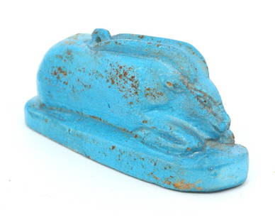 An Faience Amulet of a Hare: Discover the charm of this ancient Egyptian faience amulet, a delicate representation of a hare, an animal revered for its vitality and swiftness. The luminous turquoise blue, now bearing the marks