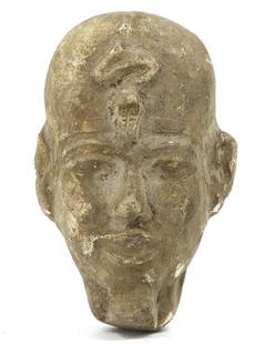 An Egyptian Glazed Terracotta Head of Ptah: Behold the visage of Ptah, the creator god of Memphis, in this glazed terracotta head from the sands of Egypt. The remnants of the glaze hint at the reverence with which this deity was once regarded,