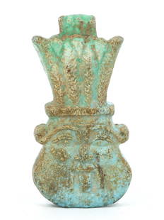 An Egyptian Faience Amulet of the God Bes: This charming faience amulet is a representation of Bes, the Egyptian deity known for his protective qualities and association with households, particularly mothers and children. The amulet's sky-blue