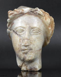 A Greco-Roman Marble Bust Fragment: From the Greco-Roman epoch, this marble bust fragment, dimensions of 7 by 6 centimeters, whispers tales of ancient grandeur. Though the ages have worn away many details, the remaining curves of the ha