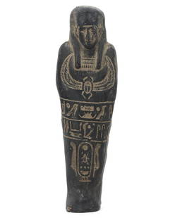 An Egyptian Steatite Ushabti with Winged scarab Carving: This steatite ushabti, standing 16.5 cm tall, bears the sacred scarab beetle carved upon its chest, a symbol of resurrection and eternal life to the Egyptians. The intricately inscribed hieroglyphs th