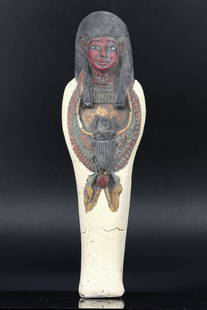 An Egyptian Guardian Ushabti with Winged Scarab: Steeped in the mystery of the Nile's culture, this ushabti statue stands as a sentinel of the afterlife. Clad in the traditional nemes headdress, it bears the sacred winged scarab, a symbol of rebirth