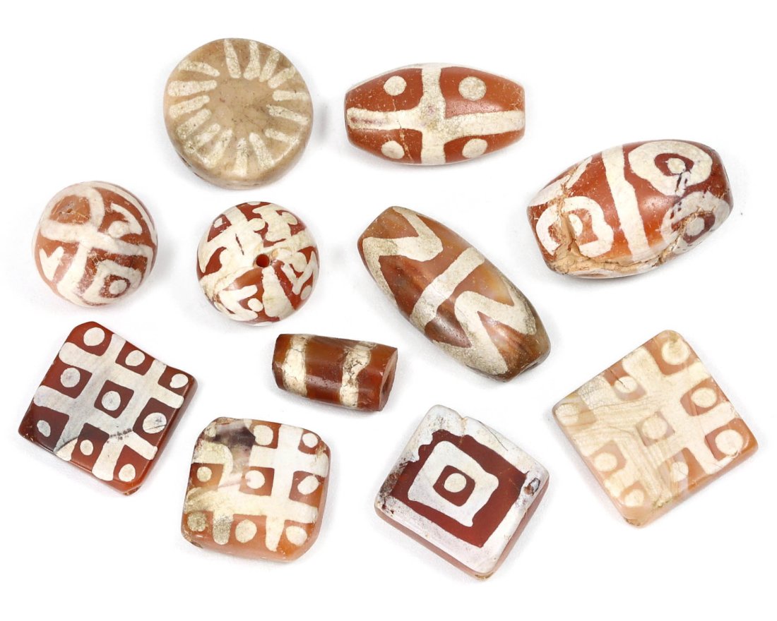 Group of 5 Medieval Himalayan Silk Road Tibetan Etched Carnelian Dzi Beads (6th-17th Century AD): These 11 remarkable Tibetan etched carnelian dzi beads are a testament to the rich history of the Himalayan Silk Road during the Medieval era (6th-17th Century AD). Ranging in dimension from 10mm to 1