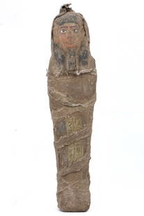 An Egyptian Guardian Ushabti, Enwrapped in Eternity: In the silent chambers of the past, this Egyptian ushabti remained a sentinel of the afterlife. Clad in a tapestry of linen, it stands resolute, a steatite embodiment of protection, its surface inscri