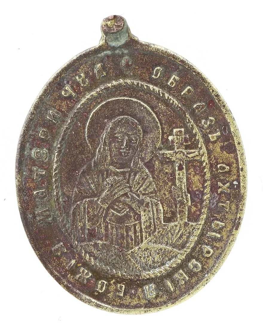 A Byzantine Bronze Medallion with Virgin Mary and Saints: This Byzantine bronze medallion, is a devout expression of faith, featuring a relief of the Virgin Mary flanked by saints, emblematic of the era's spiritual artistry. The medallion's surface is season