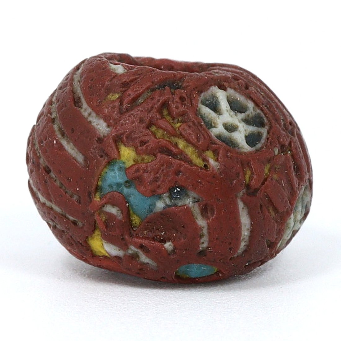 An Egyptian Glass Bead with Lotus Motif, Ptolemaic Period: Dimensions: 0.43 x 0.31 inches (1.1 x 0.8 cm)