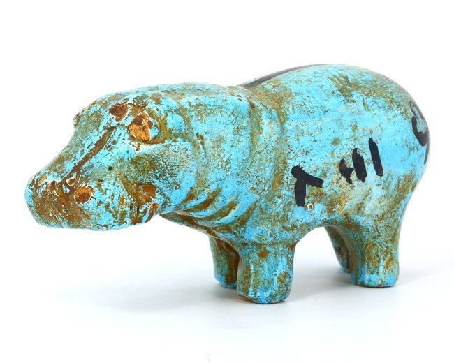 An Egyptian Glazed Steatite Hippopotamus, Late Period/Revival: This vibrant glazed steatite figurine, measuring 14 x 5 cm, depicts a hippopotamus, an animal that held significant meaning in ancient Egyptian culture, symbolizing both chaos and fertility. Whether a