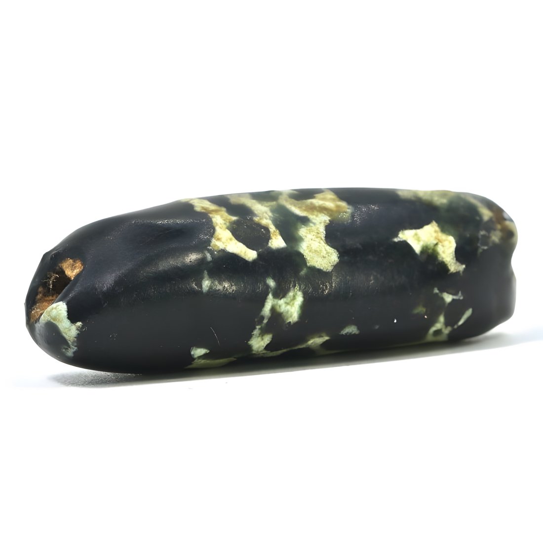 An Ancient Neolithic Dappled Pattern Jasper Agate Bead, Circa 4th Millennium BCE: The dappled pattern and elongated shape of this bead are indicative of Neolithic craftsmanship, dating back to the 4th millennium BCE. The irregular, speckled pattern, resembling lichen or moss, is ty