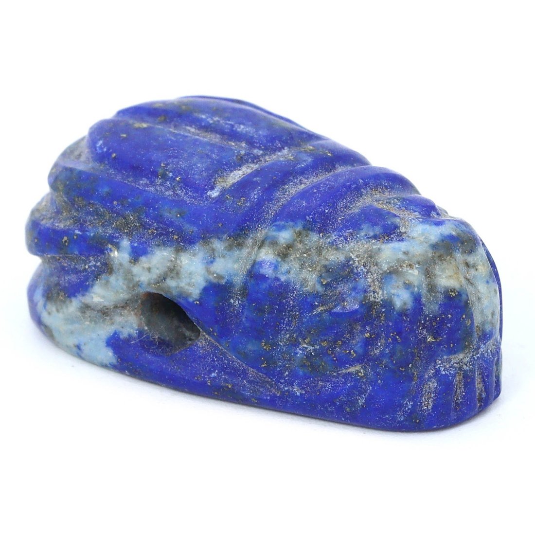 An Ancient Near Eastern Lapis Lazuli Scarab Amulet, 1st Millennium BCE: Behold this striking lapis lazuli scarab amulet from the 1st Millennium BCE, a precious relic of the Near East. Measuring approximately 0.98 by 0.59 inches, the artifact's deep celestial blue, laced w