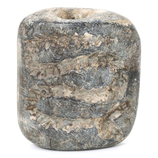 An Ancient Mesopotamian Steatite Bifacial Stamp Seal, 1st Millennium BCE: Meticulously carved from steatite, this bifacial stamp seal encapsulates the dexterity of Mesopotamian artisans. With imagery pressed on both sides, it served as a tool for sealing and identifying goo