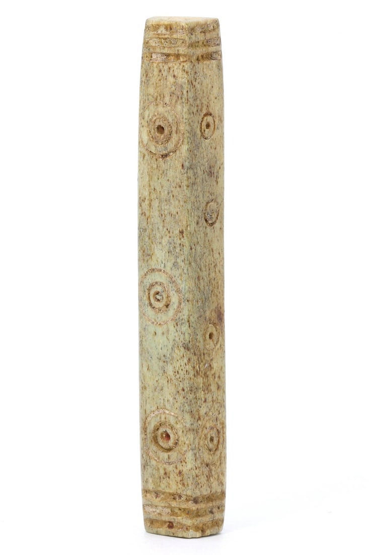 An Ancient Egyptian Bone Amulet with Eye Motif, Late Period, 664-332 BC: This elongated pillar-shaped amulet, fashioned from bone with a greenish patina, features an eye motif, a symbol of protection in ancient Egyptian belief. Such amulets were commonly used as personal p