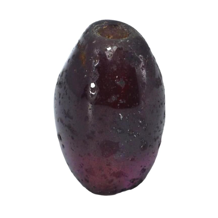 Antique Medieval Red Garnet Bead, c. 8th–15th Century CE: Crafted during the Middle Ages, a time rich in artisanal innovation, this red garnet bead displays the period's shaping skills. Garnets were highly valued for their perceived protective properties and