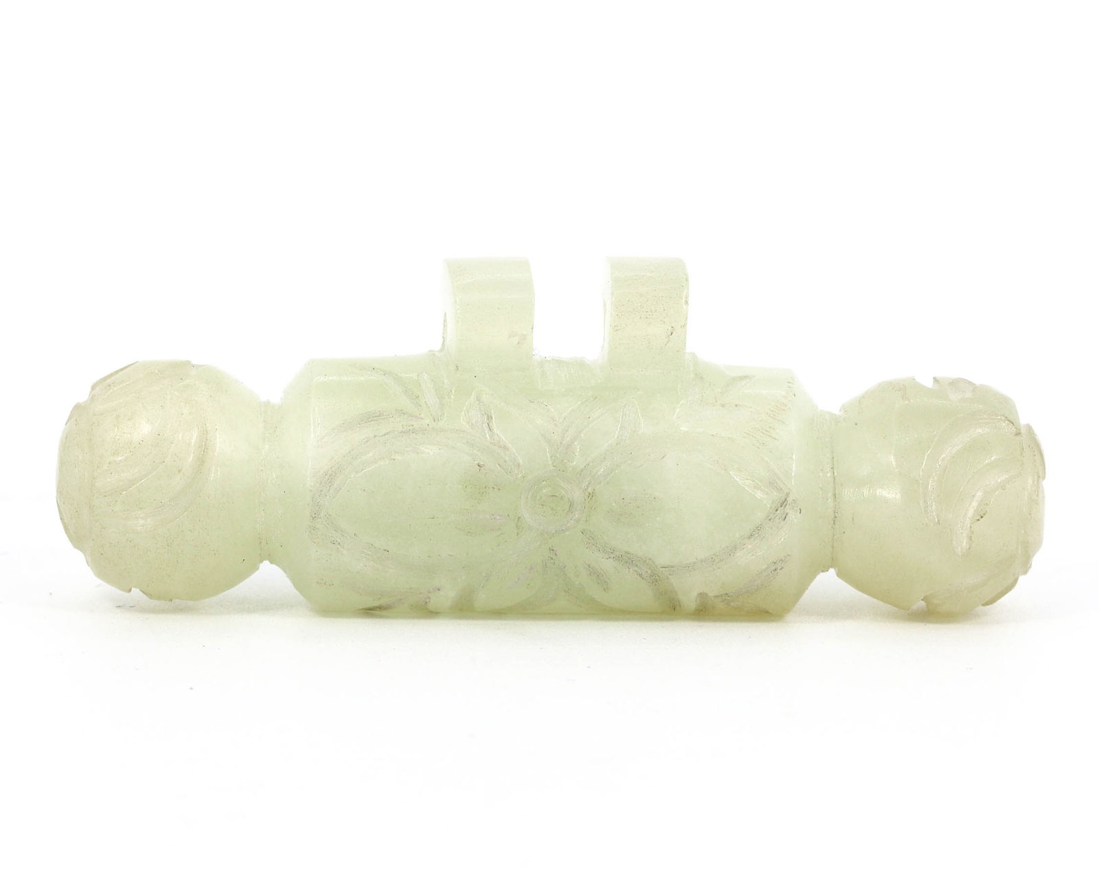 A Byzantine-Islamic Antique Floral Carved Amulet, Circa 8th-10th Century: This delicately carved amulet, measuring 6.5 x 2 cm, possibly hails from the Byzantine-Islamic period, given its stylistic floral motifs and the light green semi-precious stone from which it is fashio