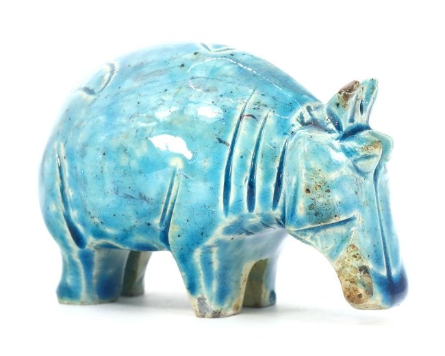 An Egyptian Glazed Steatite Hippopotamus, Late Period/Revival: This vibrant glazed steatite figurine, measuring 7.6 x 5 cm, depicts a hippopotamus, an animal that held significant meaning in ancient Egyptian culture, symbolizing both chaos and fertility. Whether 