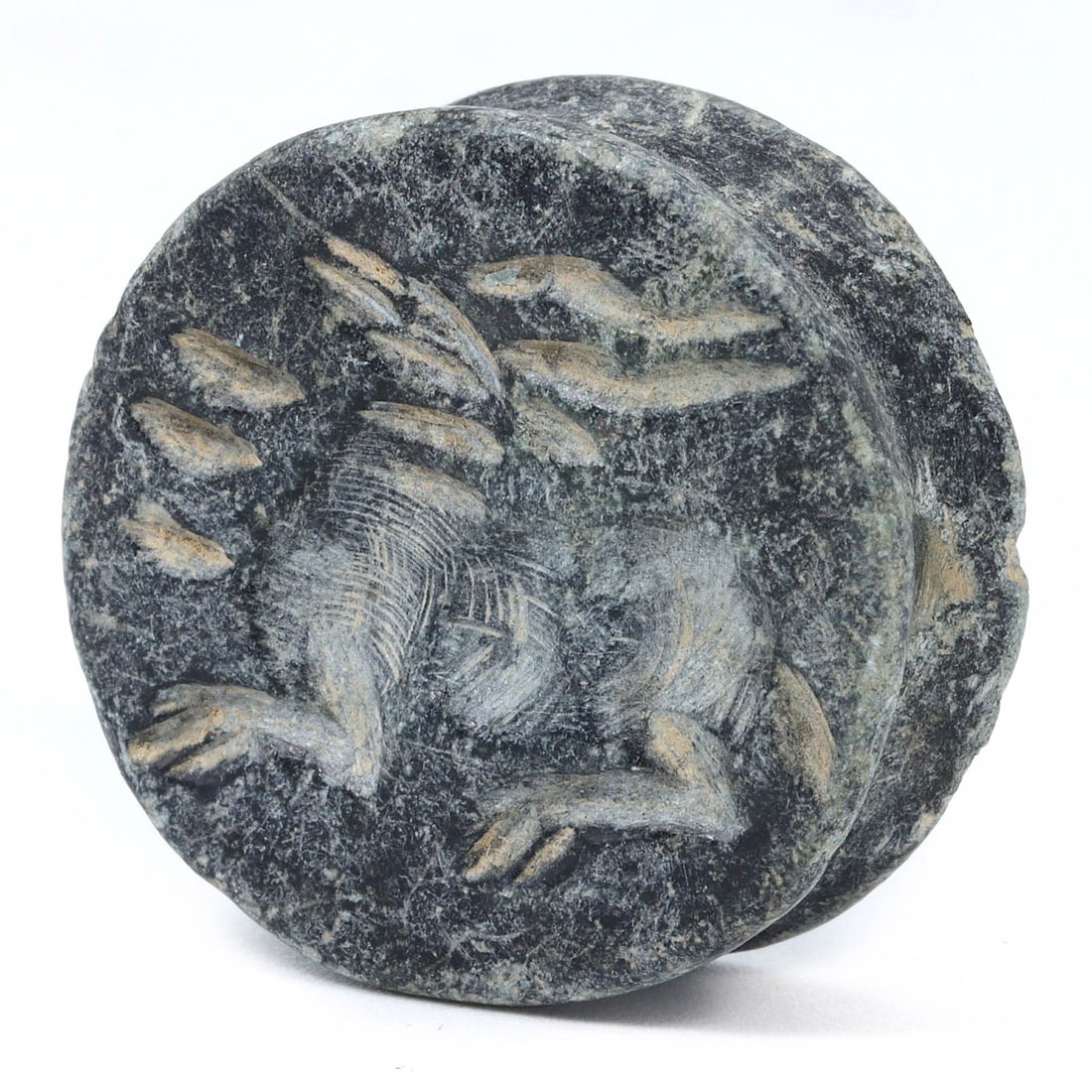 An Ancient Persian Steatite Seal, Curved Motif, 1st Millennium BCE: This steatite seal from ancient Persia is etched with a detailed curved motif, a characteristic style for the region. Seals like this were used to secure and identify goods and correspondence, and oft